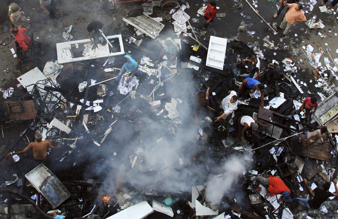 A scene of the
aftermath of a fire that was set in the headquarters of the
Freedom and Justice Party by anti-Morsi protesters during clashes
between them and supporters of Egyptian president Mohamed Morsi
in Sedy Gaber in Alexandria, June 28, 2013. (Reuters)
